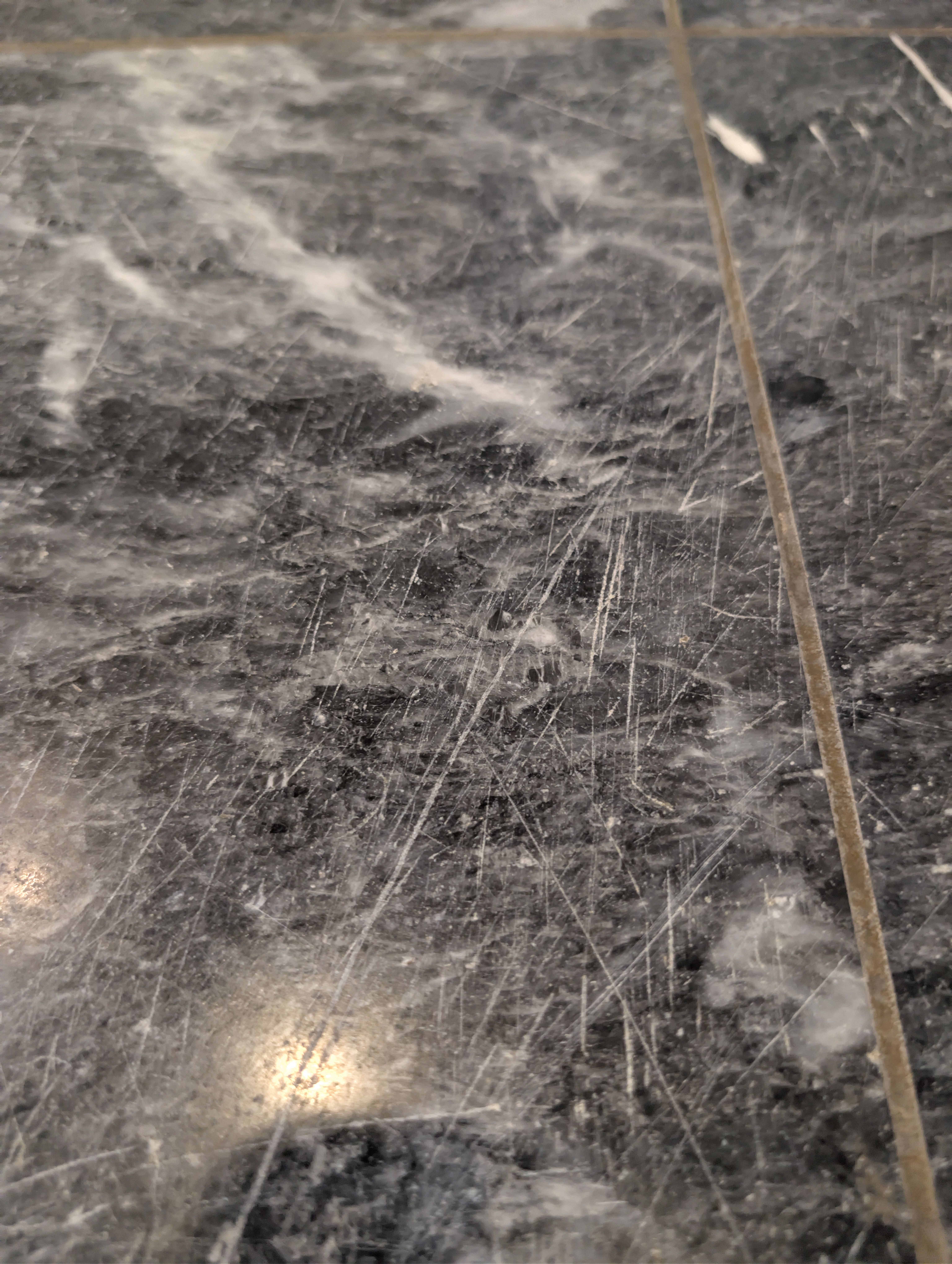 Deep Equipment Scratches on Black Marble - Virtuoso Building